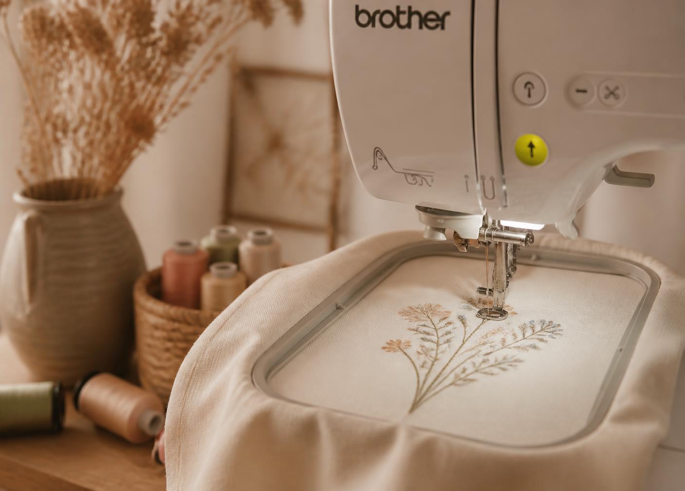 Single-needle Brother VR embroidery machine stitching a wildflower design onto cream fabric